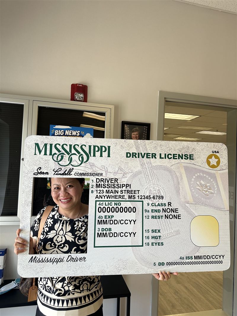 Smiling with the Mississippi new-driver photo frame at the Department of Public Safety office